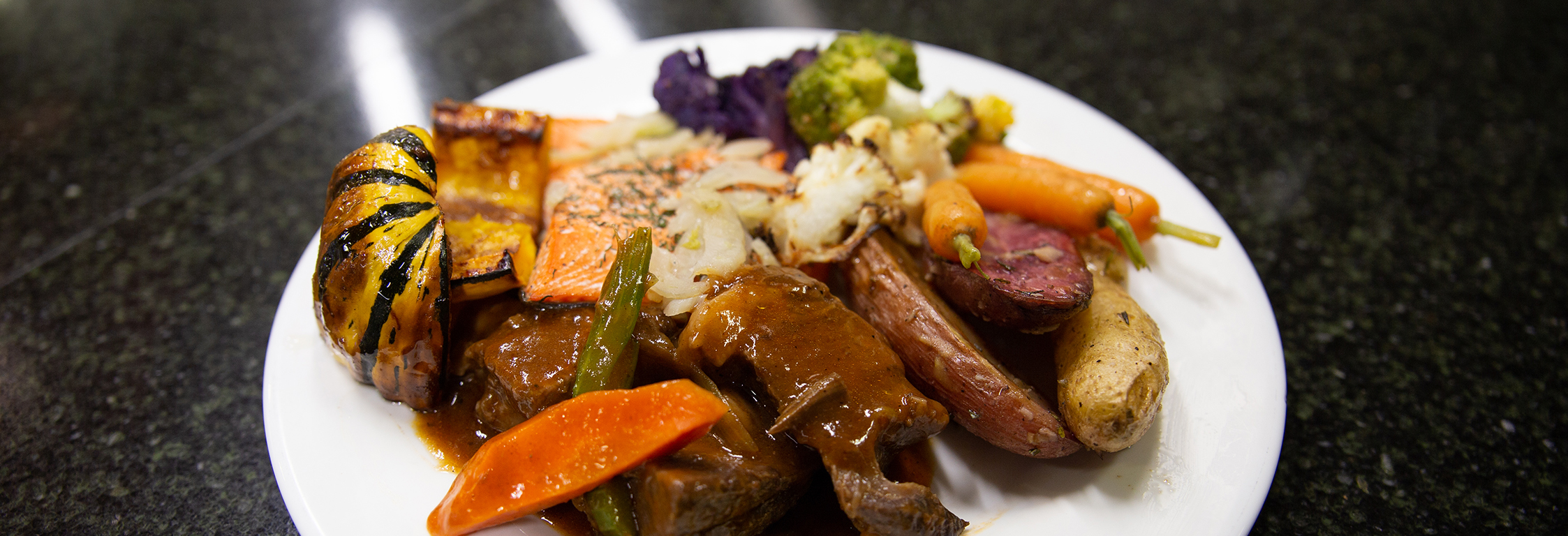 A plate of fall harvest favorites, including salmon, squash, and potatoes.