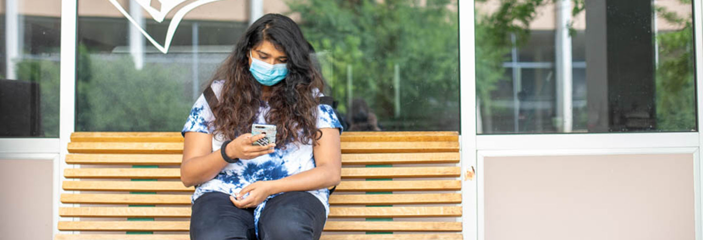 A student orders food on their phone outside Flix.