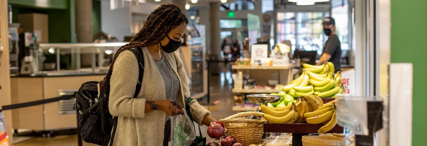 student grabs an onion with a mask on