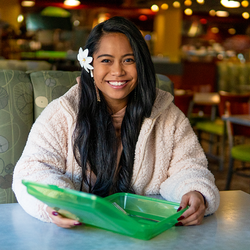 A student holding a reusable container.