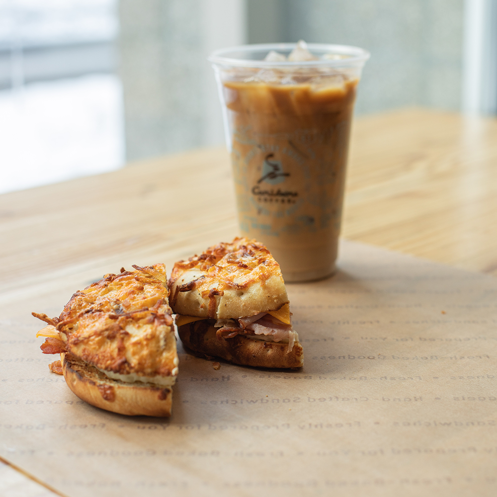 A breakfast sandwich and iced coffee.