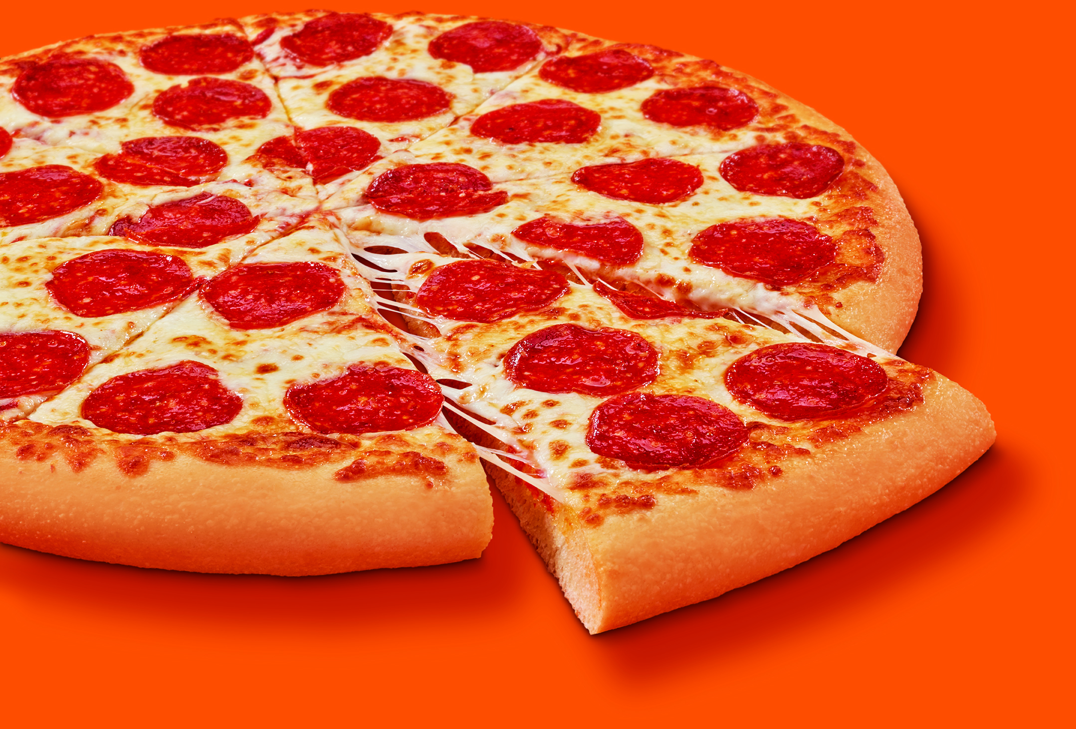 pepperoni pizza on orange background