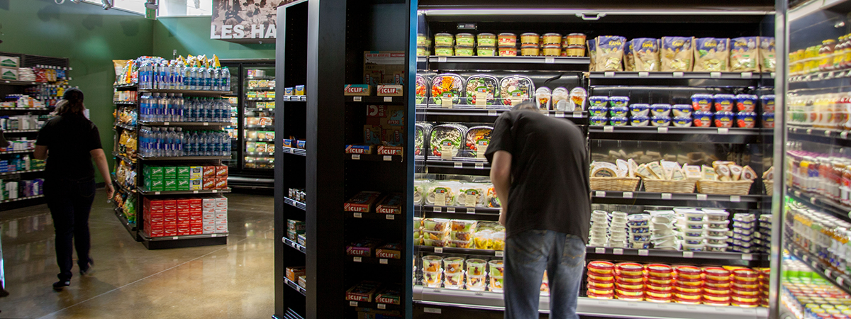 Man shopping in the refrigerated area.