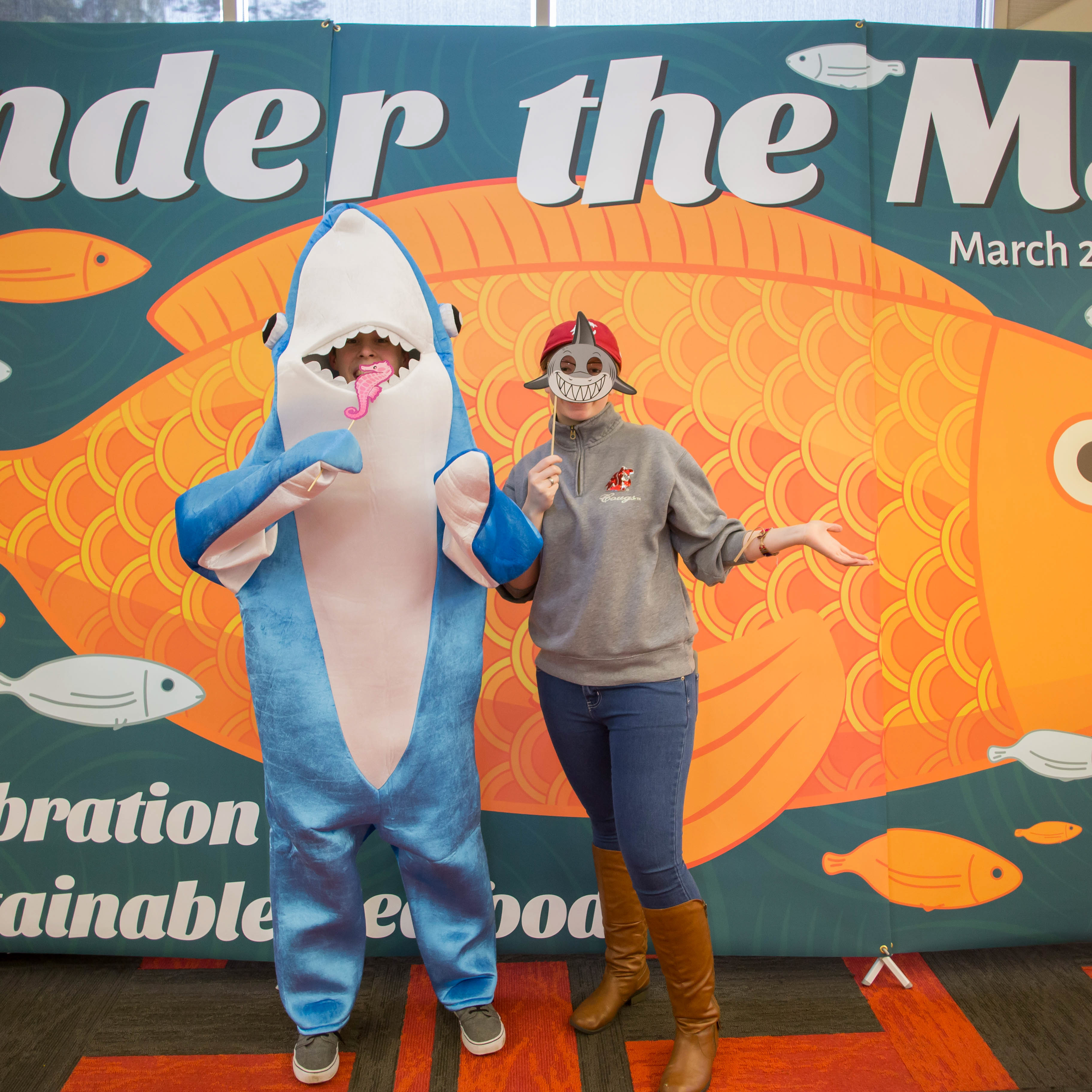 Dining employee dressed up as shark next to other employee for MSC event.