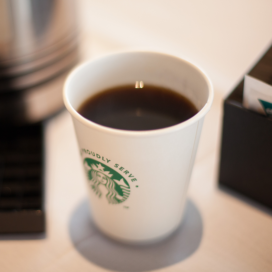 A hot cup of coffee in a Starbucks cup.